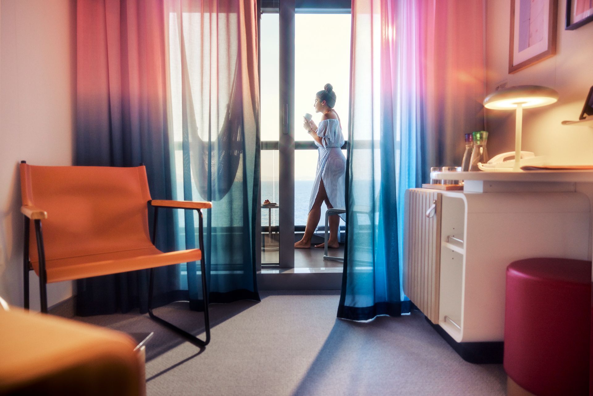 Guest enjoying ocean views from a cabin balcony