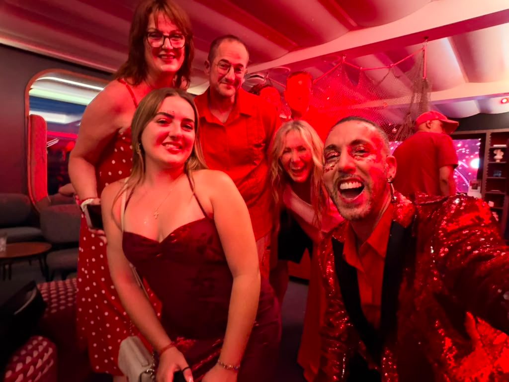 Travelers in red outfits taking a selfie at Scarlet Night