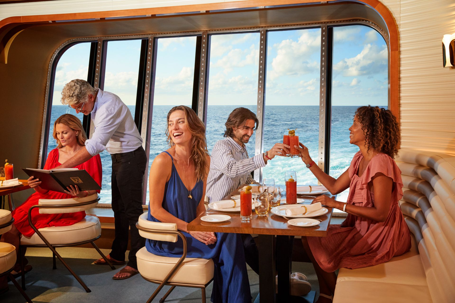 Friends toasting over the ocean