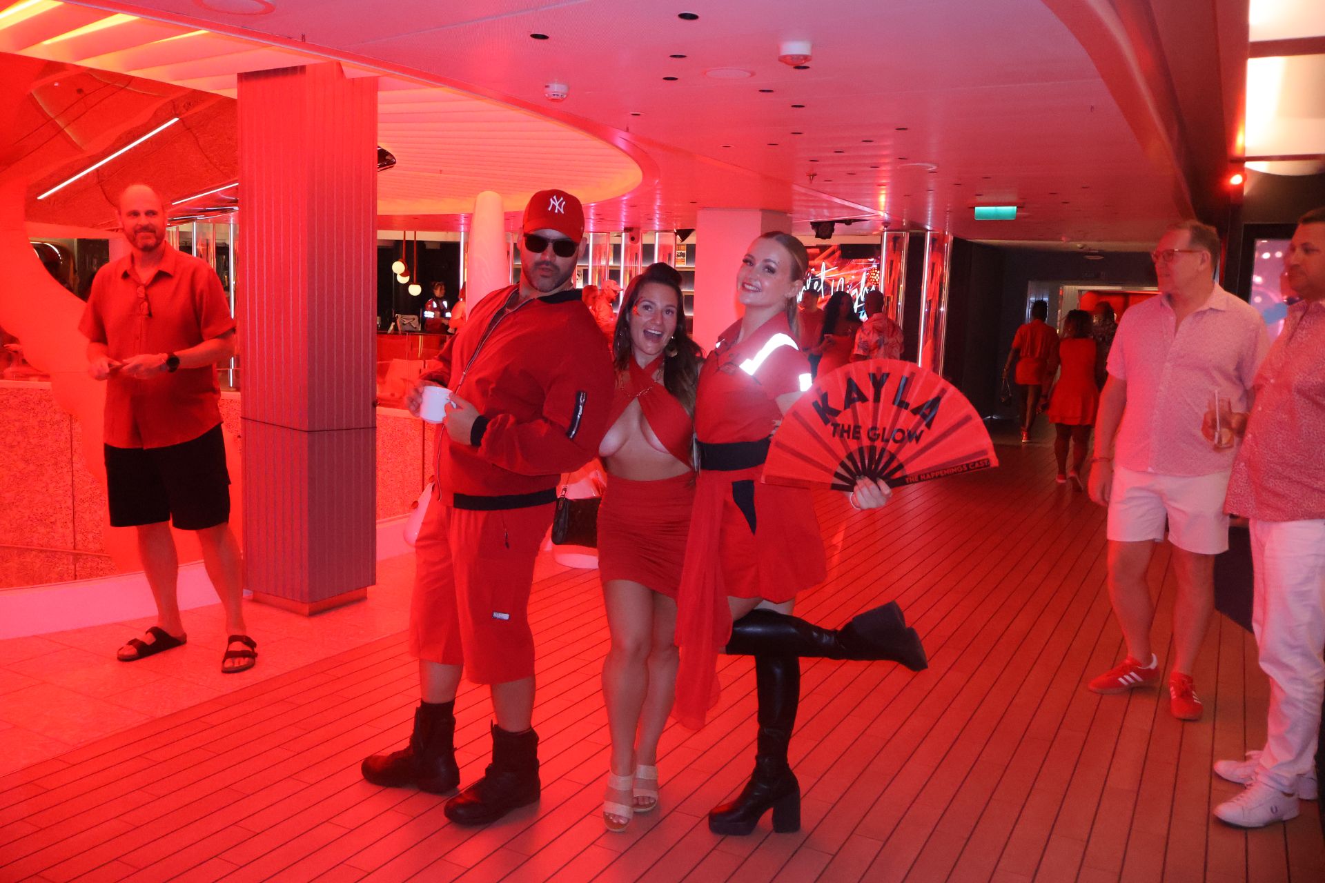 Sailors in red posing on the ship's deck